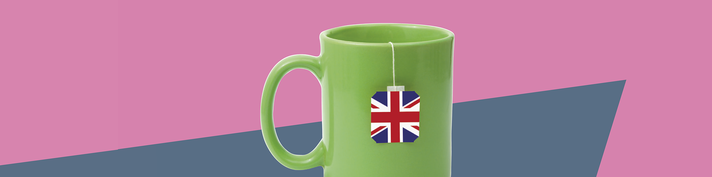 Grüne Teetasse mit Britischer Flagge vor pinkfarbenem Hintergrund