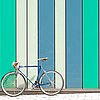 Fotografie eines Fahrrads vor bunt gestreifter Fassade.