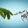 eine mit Gras bewachsene Hand und eine Computerhand berühren sich